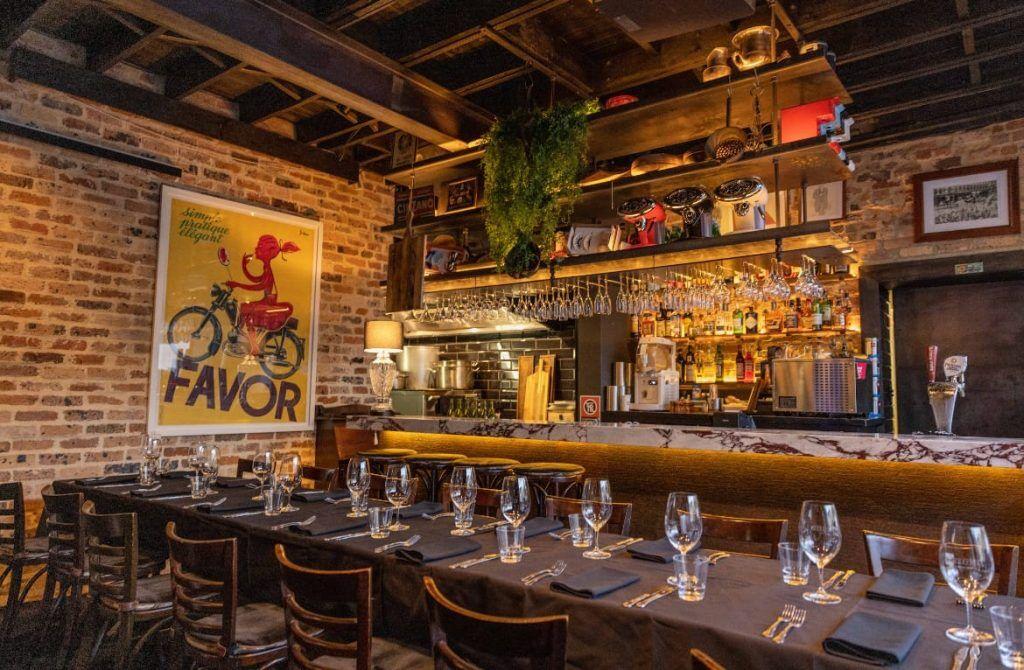 Verde private dining, long table set for dinner beside the bar